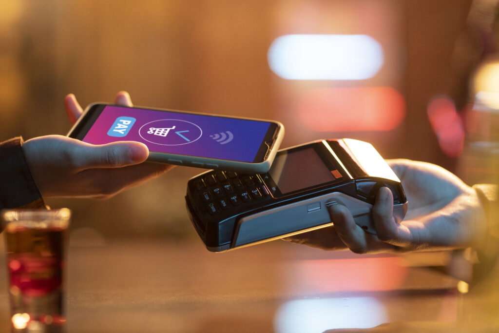 side view adult paying with card side view adult paying with card